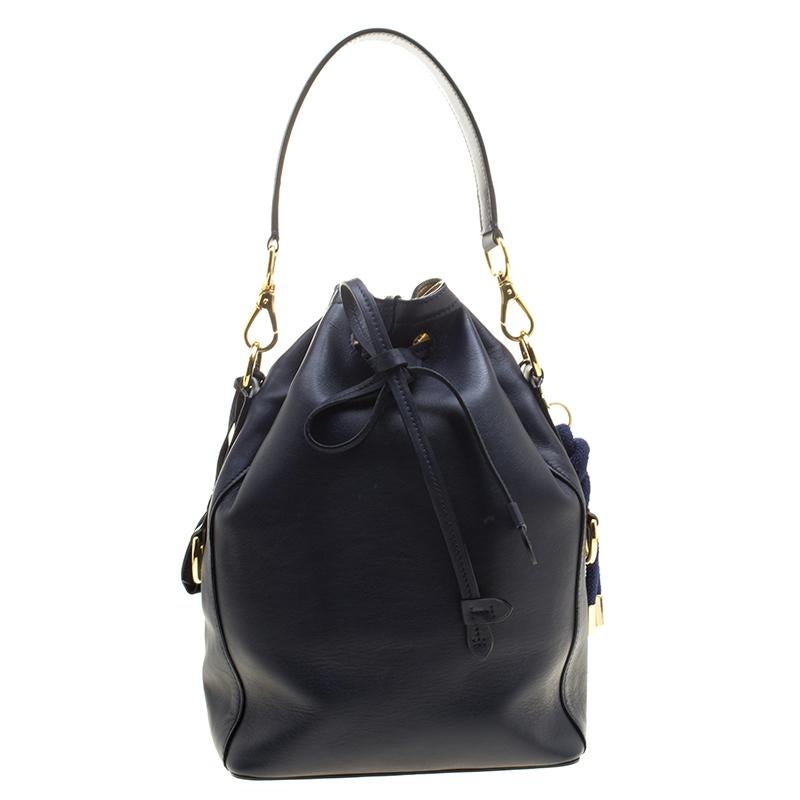 Ralph Lauren's bucket bag will add a stylish element to your wardrobe. Crafted with blue leather, it has a soft structure with a single flap pocket adorning the front and secured with a gold-tone push lock closure. The top has a drawstring closure