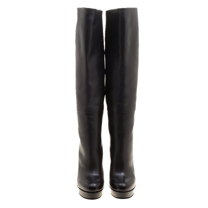 Gucci brings you this fabulous pair of knee high boots that will give you confidence and loads of style. They've been crafted from leather in a classy black shade and styled with platforms and 14.5 cm heels bound to lift you with beauty.

Includes: