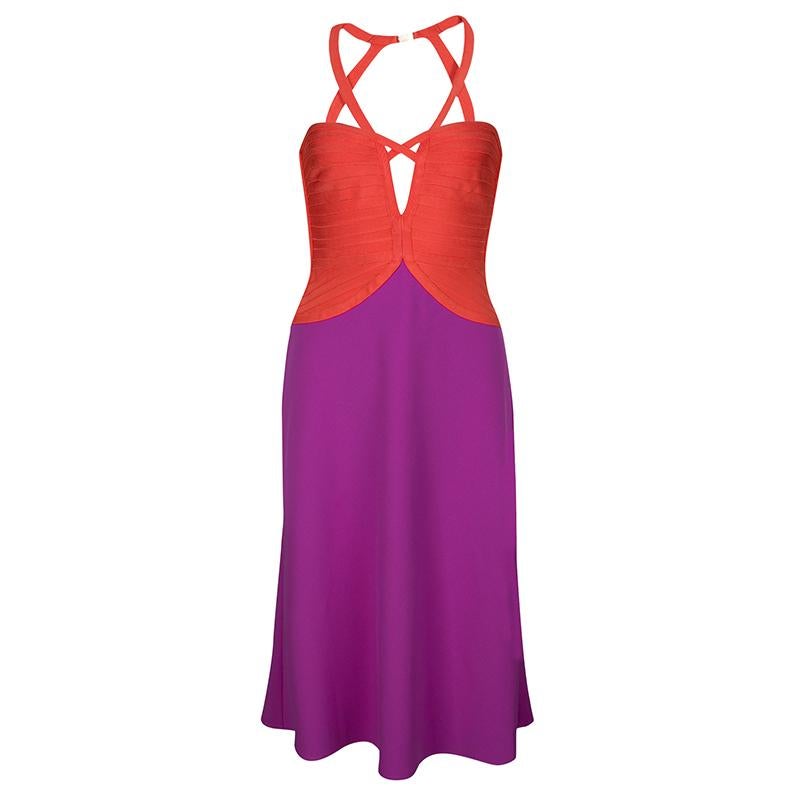 To bedazzle the crowd with your stunning style statement pick this lively, spirited dress from Herve Leger. Fashioned in a colorblock design, the dress has a fitted, orange bodice with panels and coquettish cutout detail at the center. It runs down