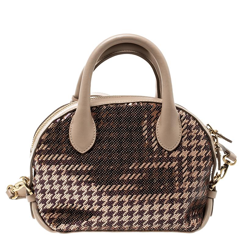 Elegantly crafted in leather and beautifully designed with sequins, this smart and stylish Fiamma satchel from the house of Salvatore Ferragamo is for the trendy you! This beige bag offers a young mix of the timeless style and new cool. Lined with