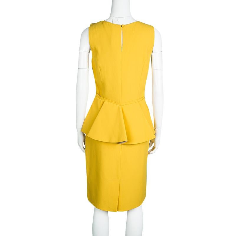 You can only feel confident and stylish when you are wearing this Fendi's vibrant yellow dress. Displaying half-peplum design at the rear, this sleeveless dress is cut to a fitted shape and secured with a buttoned closure. Style this heels and tote