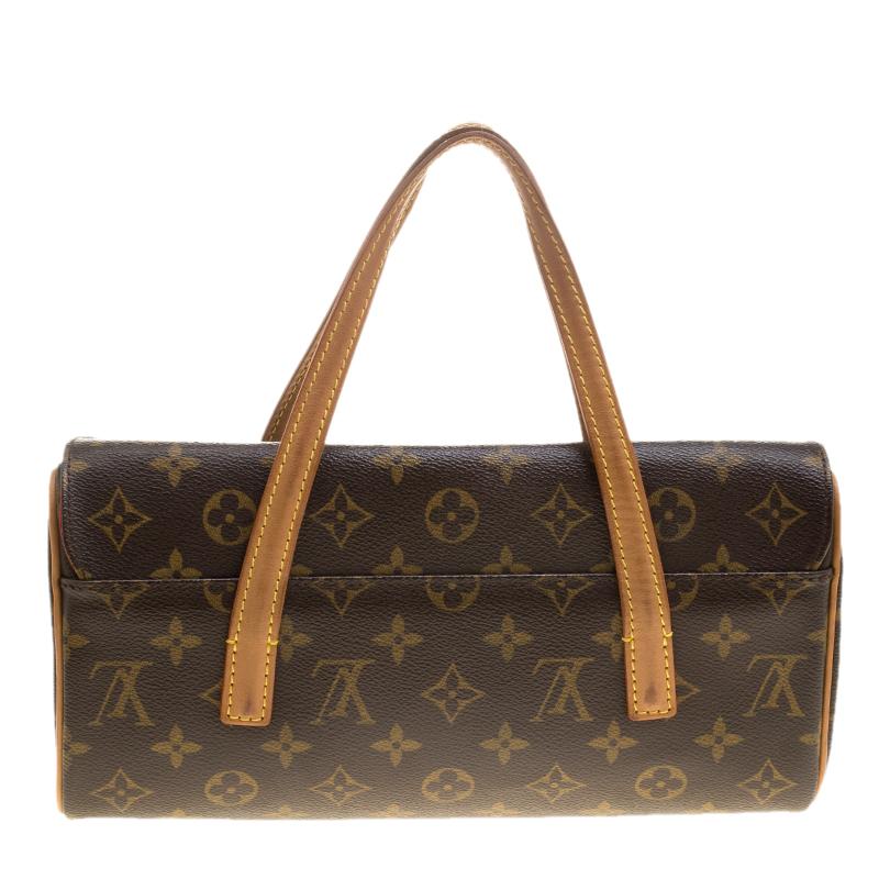 It is every woman's dream to own a Louis Vuitton handbag as appealing as this one. Crafted from their signature monogram canvas, this bag features two top handles in contrasting tan color and a flap with a snap button. The Alcantara-lined interior