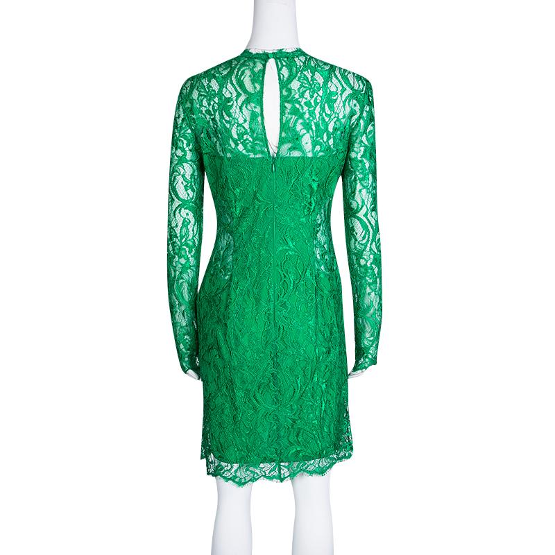 Emilio Pucci's green dress is delightfully feminine owing to its slim silhouette and design. It is embellished with lacework and features a cutout detail on the neckline with a dangling tassel. The dress is designed with long sleeves, and a zip and