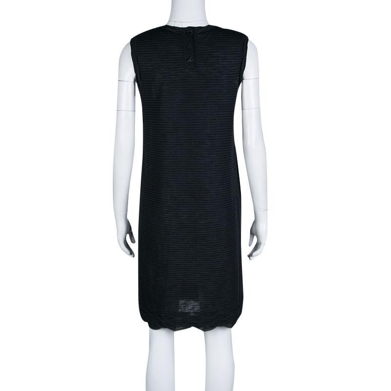 You'll absolutely love wearing this dress from Chanel as it is stylish and bound to give you a gorgeous fit. It has been tailored from the finest fabrics and designed as a sleeveless with stripes all over and scallop detailing on the front and