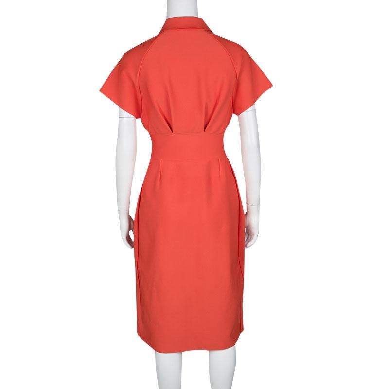 The minimalist yet amazing design of this Dior dress makes it perfect for both work and otherwise. The collar and zip front keep it formal while the fluid, pleated bottom lends comfort. Completed with a bright orange hue, wear it with simple heels
