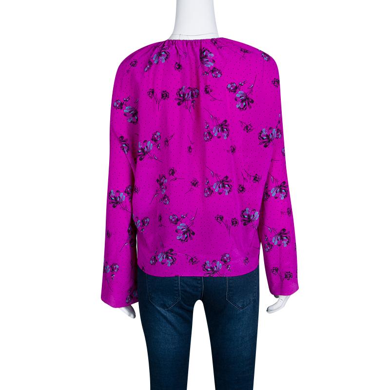 Celebrate summer with this gorgeous floral print top from Balenciaga. The bright fuchsia top comes with long sleeves and a drawstring neckline that makes for a very casual and chic look. The pure silk material gives you the maximum comfort as you