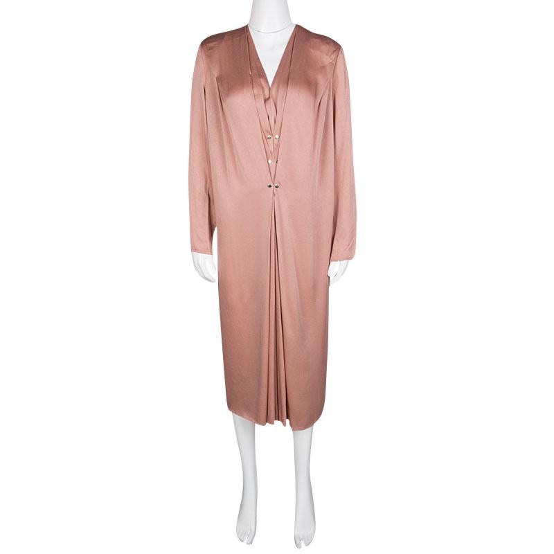 Give an elegant spin to your evening look with this Lanvin dress. Crafted in soft peach hue, the dress features a pleat detail along the center front creating a layer-like silhouette and is detailed with gold-tone embellishments. Graced with a comfy