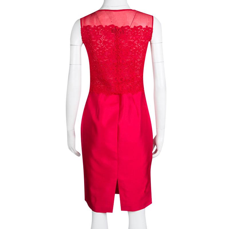 CH Carolina Herrera sheath dress is all about feminine charm, grace, and subtlety. This red dress designed in a sleeveless style featuring beautiful lace bodice that goes sheer at the shoulders. Exuding a glossy effect, the outfit is cut from