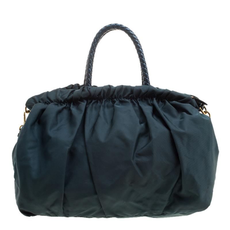 Carry all your essentials for the day with ease or take it with you while you travel, this Prada Convertible tote is elegant and stylish with a practical purpose. Crafted in dark blue nylon material, this bag can be paired with almost any day time
