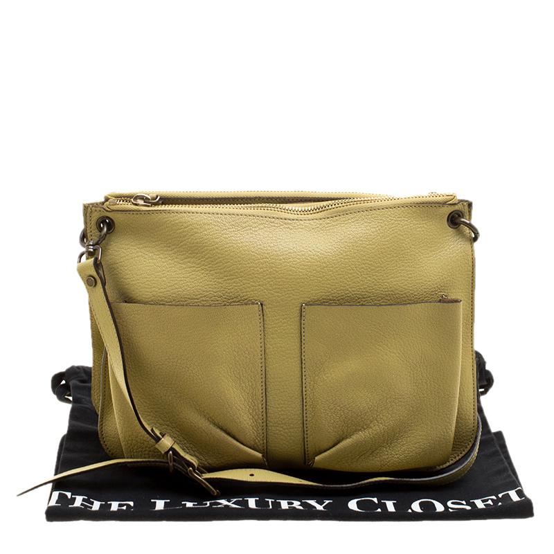 Add some effortless style and casual ease to your everyday looks with this Marni Bandoleer crossbody bag. Crafted in yellow green leather, this bag features two zippered compartments at the top along with two slip pockets at the front to keep you