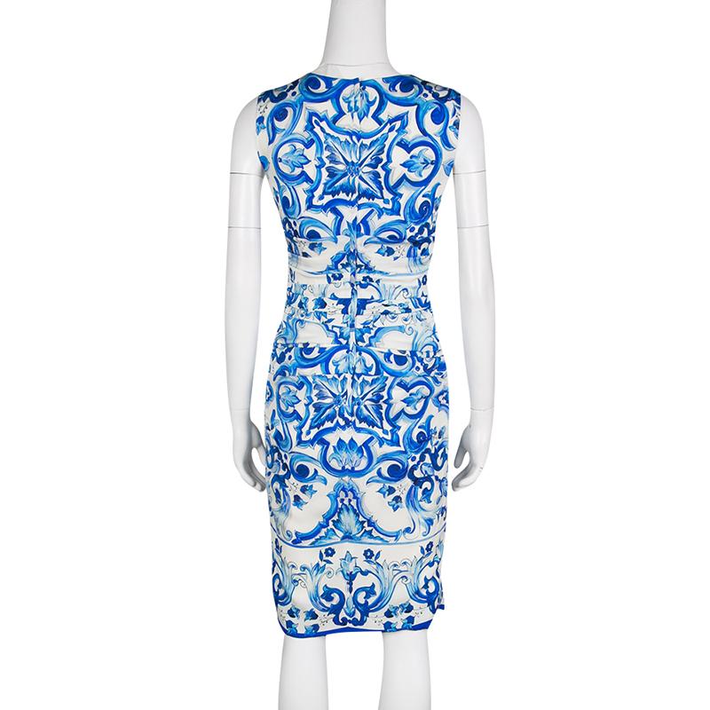 Dolce and Gabbana is loved for their dramatic prints and lush designs. The blue and white Majolica print adds an exotic feel to this sleeveless dress. Designed with a fitted bodice and rushing at the waist, this visually delightful dress can be worn