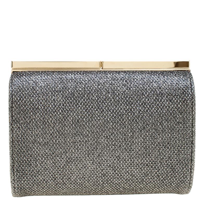 Add the much needed touch of bling to your outfit with this stunning glitter clutch by the designer label of Jimmy Choo. Simplistic in its tube shape, this clutch carries the bare essentials inside it. The double clasp closure on the top of the bag