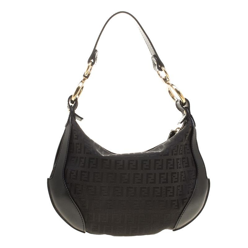 This Fendi hobo will make a perfect everyday bag. Crafted from signature Zucchino canvas with black leather trims, the bag features a leather shoulder strap, a front zipper pocket, and a Fendi charm. Its spacious interior is lined with