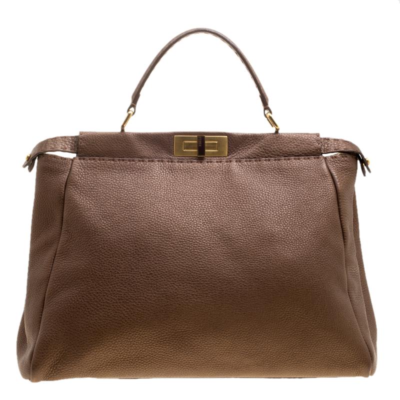 This delightful Peekaboo from Fendi is highly coveted, and since its birth in 2009, it has swayed us with its shape, design, and beauty. This brown version is a joy to witness! It comes meticulously crafted from leather and designed with a top