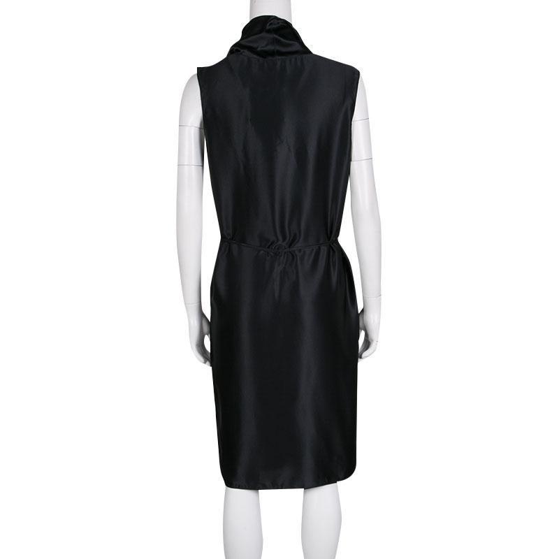 This black satin dress from Lanvin is a gorgeous piece to don for your upcoming events. Designed in a sleeveless style, it features a draped bodice with a self-tie belt at the waist. It is crafted with silk and will lend you a classy