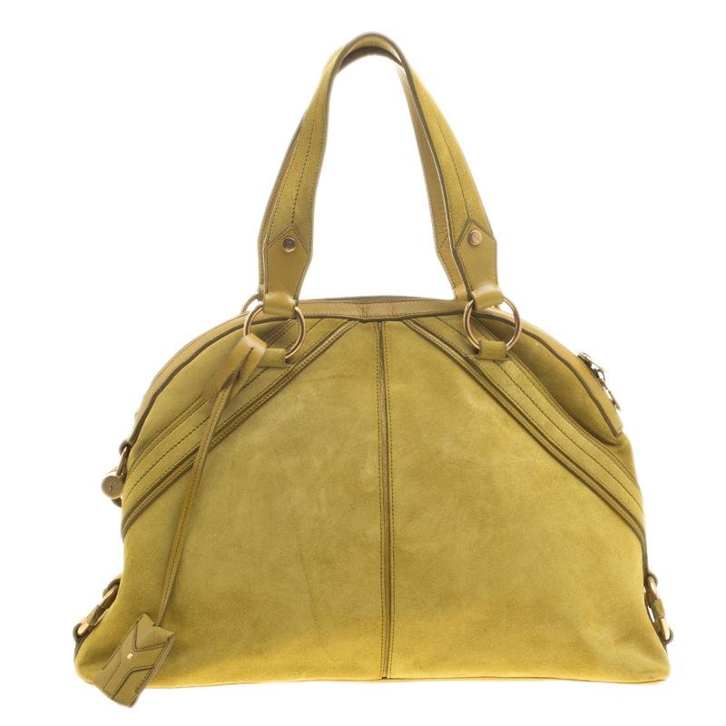 Create a sensational look with this handbag in radiant yellow hue. Watch your friends go gaga when you make a brilliant appearance with this dashing suede and leather item. Flaunt this satin-lined Saint Laurent Paris bag and amaze everyone with your