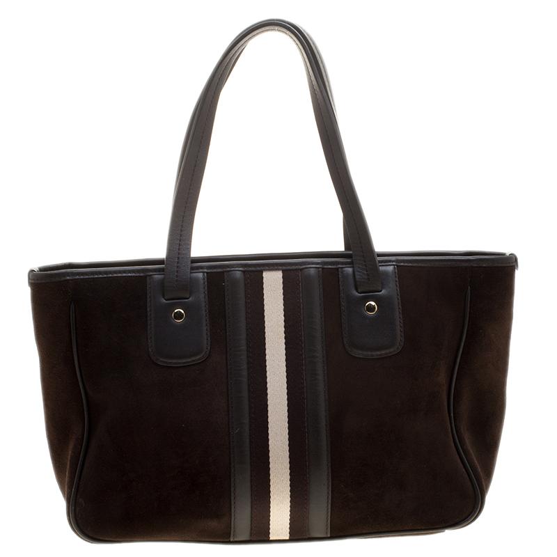 A classic number from the house of Bally, this tote features a suede body and trimmed with leather. The minimal and classic style comes detailed with a leather ID tag, an open top silhouette and two flat top handles. We think it makes a great bag