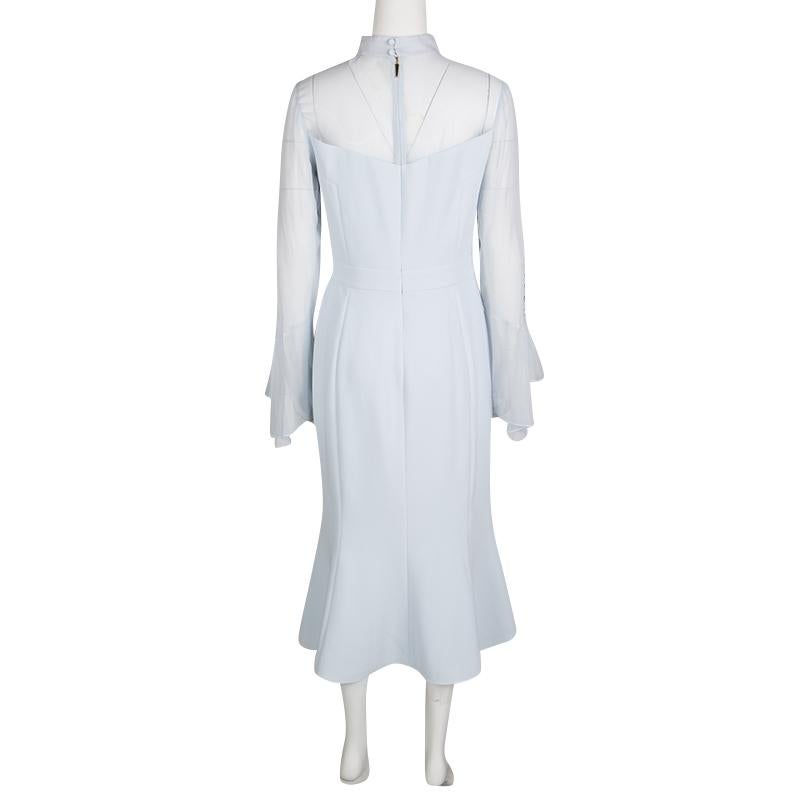 This powder blue dress from Prabal Gurung is a closet classic in every sense. The sheer sleeves and shoulders meet cute button details to style this understated yet super elegant dress for your formal dos. Complete with a sweet convenient length,