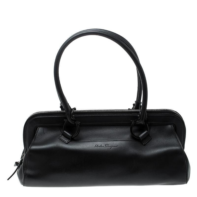 We bring you this carefully designed bag made from leather, crafted with love and passion. This attractive and durable satchel by Salvatore Ferragamo will surely not let you down. It comes in black with two handles and a spacious fabric