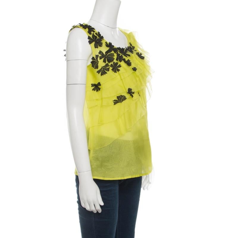 Oscar de la Renta's top is a great casual piece that can be paired with anything, from shorts and skirts to jeans. It features a chartreuse green hue and ruffles design which is accented with contrasting floral appliques lending a pretty, feminine