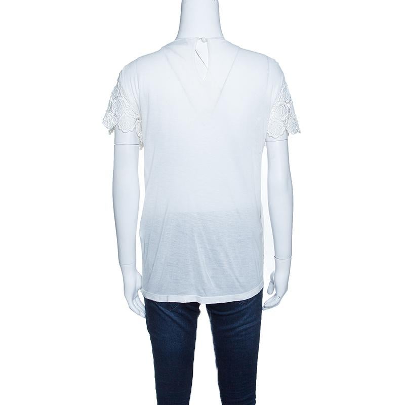 Valentino's off-white top echoes romantic aesthetics and a chic appeal. It is glorified with floral lace overlay on the front with a solid rear. Lightweight and comfortable, it features short sleeves and a relaxed shape. Wear it with fitted bottoms