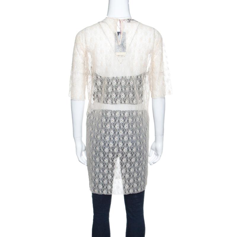 Envision yourself in Stella McCartney's feminine charm with this beige-coloured top. It is creatively designed with rosebud lace overlay and an elongated length. Cut in a sheer body; this top will look cool with contrasting bottoms.

Includes: The