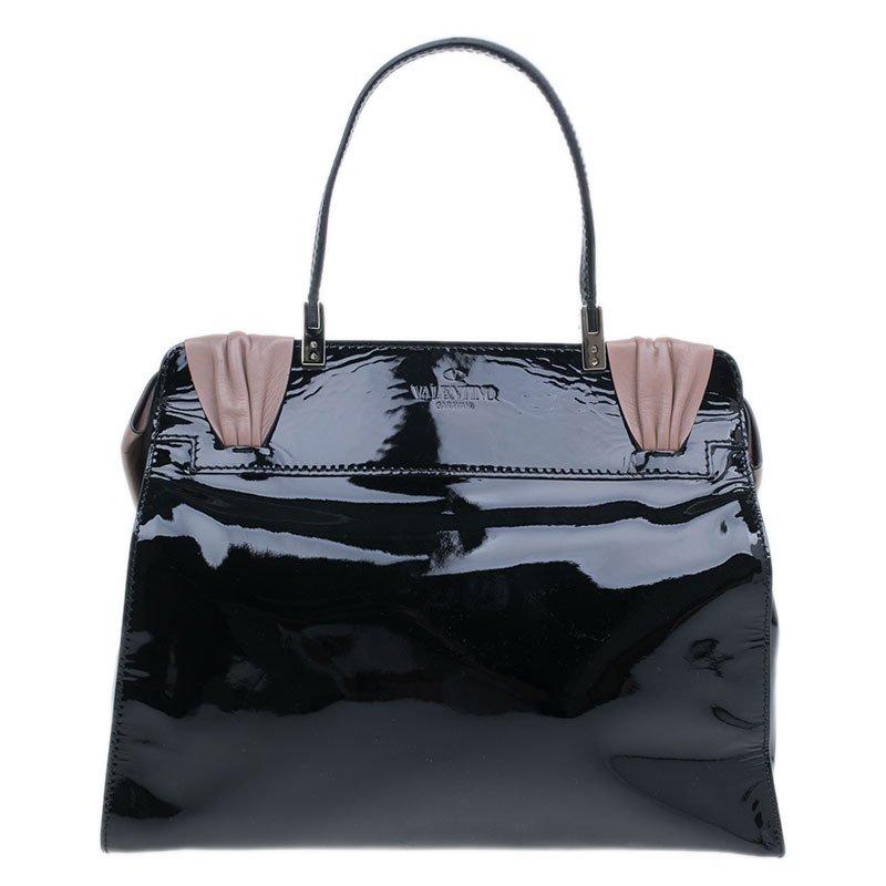 Carry this chic Aphrodite Bow Top bag from the fashion house of Valentino. Crafted from raffia in leopard print, it features patent leather details, a top handle and a decorative cocoa leather bow. The fabric lining is secured with a magnetic