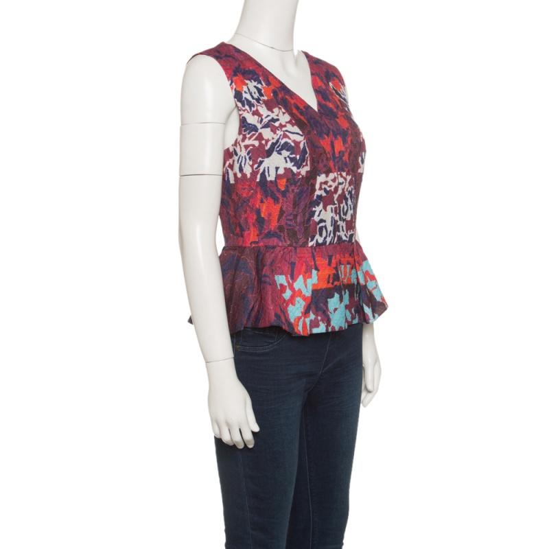 Characterized by the waist-defining peplum, this Peter Pilotto top is a wow separate for your evening outings. It is cut from a cloque silk blend flaunting an artful water orchid print. Team this with your pencil skirts and high heels for a statemnt