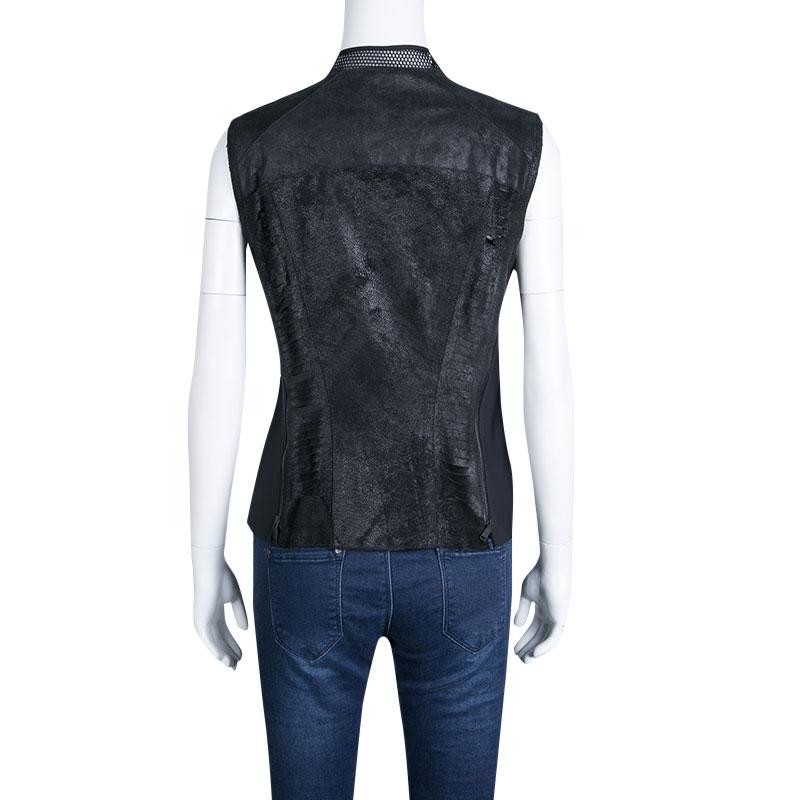 A contemporary take on the classic jackets, this Elie Tahari vest is a one-of-a-kind piece. With the spread collar and zipper detailing, this black vest, cut from distressed lamb leather, is a fabulous addition to any ensemble. The coordinating side