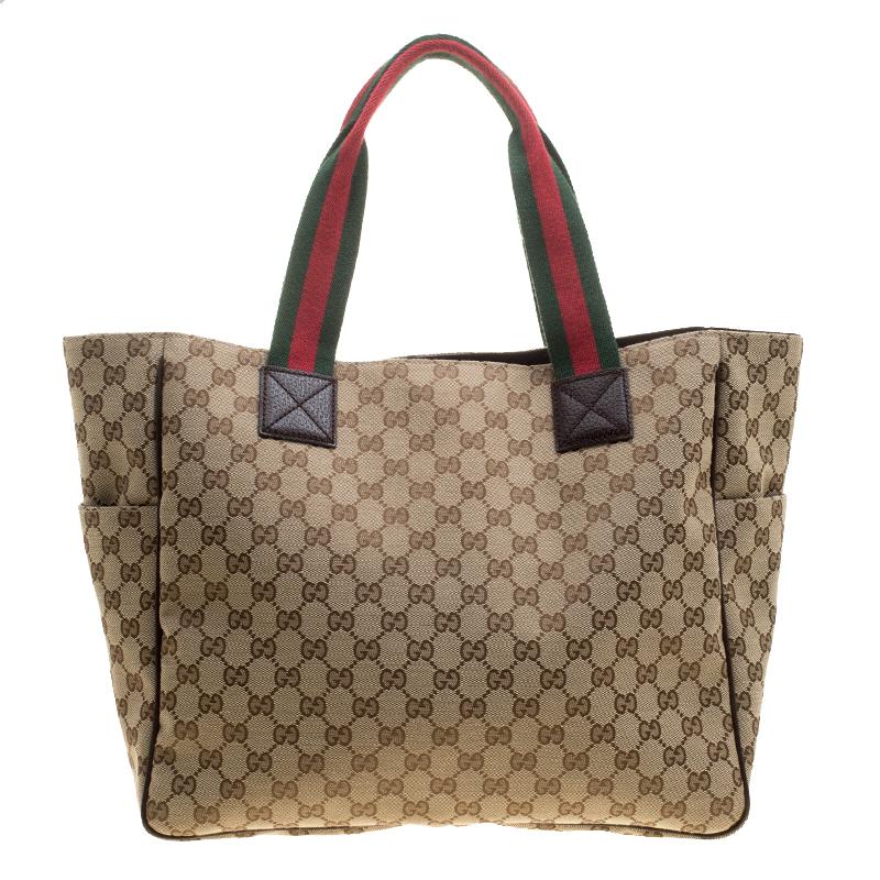 Made from GG canvas, and detailed with pockets on the front, this Gucci tote will add just the right amount of luxury to your closet. The bag carries a spacious fabric interior and two web handles. This piece is definitely an ideal everyday