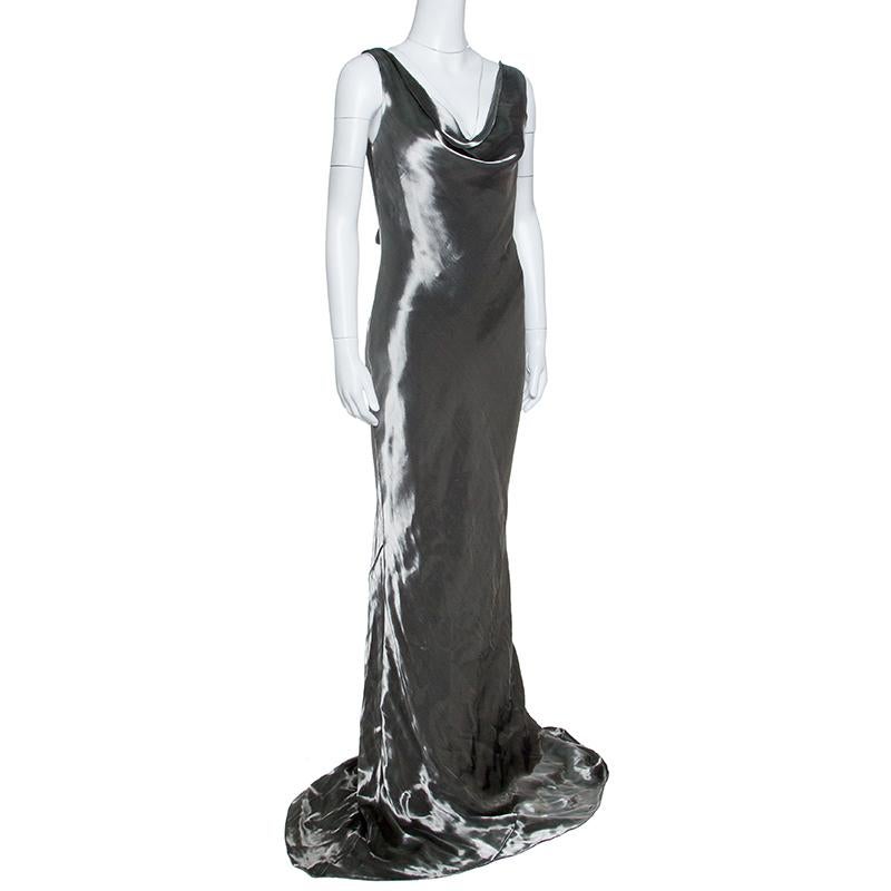 Leave everyone in awe whenever you step out in this gorgeous gown from Alexander McQueen. Made from the finest materials, the metallic silver gown has a dreamy silhouette with a draped neckline, open back and a flowy hem. You can assemble the
