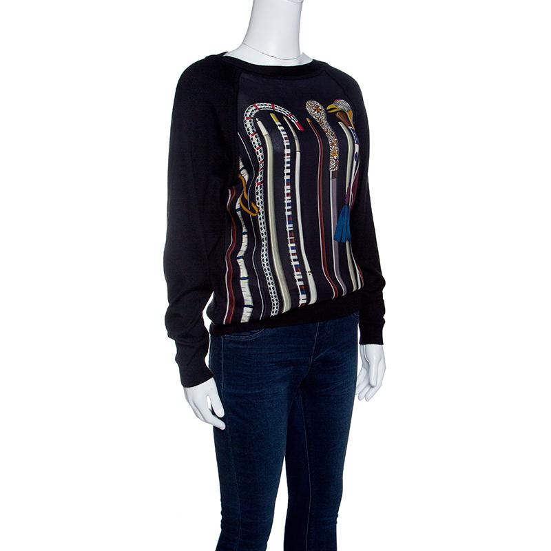 How stylish is this sweater from Hermes! Beautifully made from cashmere, this sweater will brighten all your winter outings. It has a simple design with long sleeves and different types of canes printed on the front. This creation can be perfectly