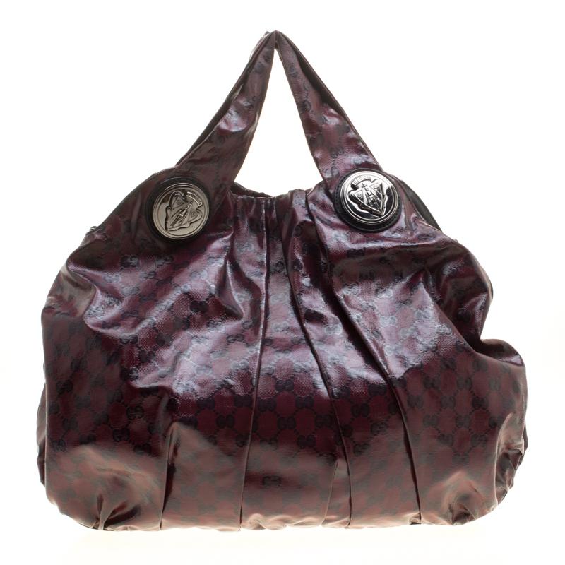 This Gucci hobo is built for everyday use. Crafted from GG Crystal canvas, it has a maroon exterior and two handles for you to easily parade it. The fabric insides are spacious and the hobo is complete with the signature emblems.

Includes: The
