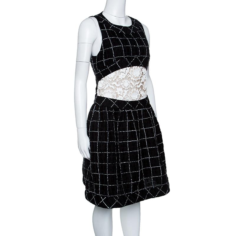From Chanel's 2014 SS collection twirls in this sleeveless dress that has been finely tailored from quality fabrics and designed with check patterns and lace inserts on the midriff. A back zipper is provided to help you slip into it.

Includes: The