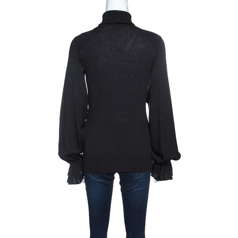 Layer yourself with this Fendi grey sweater for the days when the temperature cools. It is a great casual piece with long sleeves featuring ruffled cuffs. It is cut from 100% wool that allows you a snug wearing experience. Finished with a