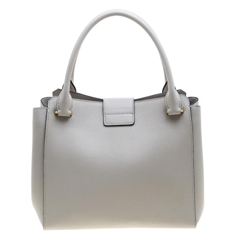 Featuring two handles, and a large buckle flap, this Burberry tote is the kind of bag you would want to swing every day. The leather bag features a capacious fabric compartment to house all your essentials and a check shoulder strap for easy usage.