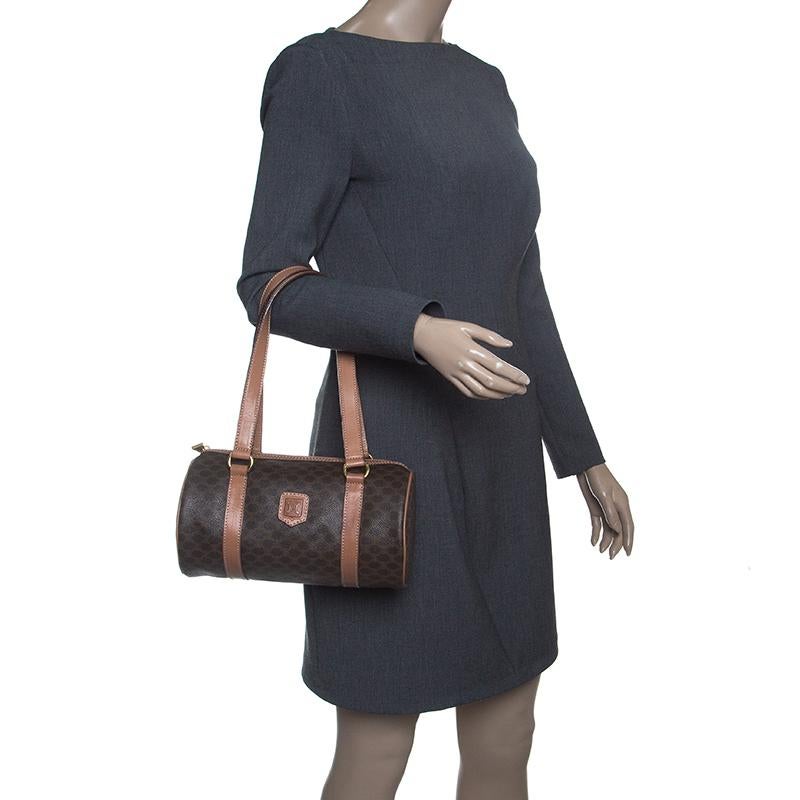 Celine Boston bags are a craze among the fashion enthusiasts. Ideal for stylish travellers, this bag is crafted with macadam coated canvas in deep brown hue. Featuring twin handles, top zip closure and a spacious leather-lined interior, this bag is