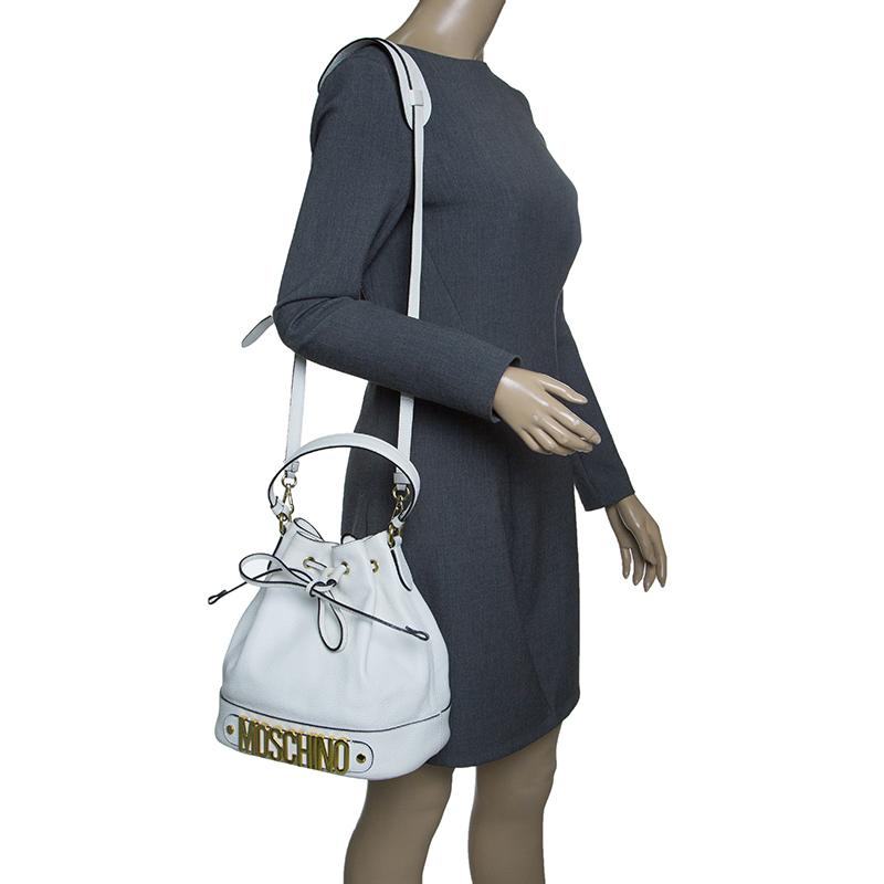 Make everyone nod in approval when you step out swaying this Moschino bag. It has been crafted from leather and styled with a shoulder strap and a top handle. The bag has a drawstring closure that leads to a nylon interior and it is perfectly made