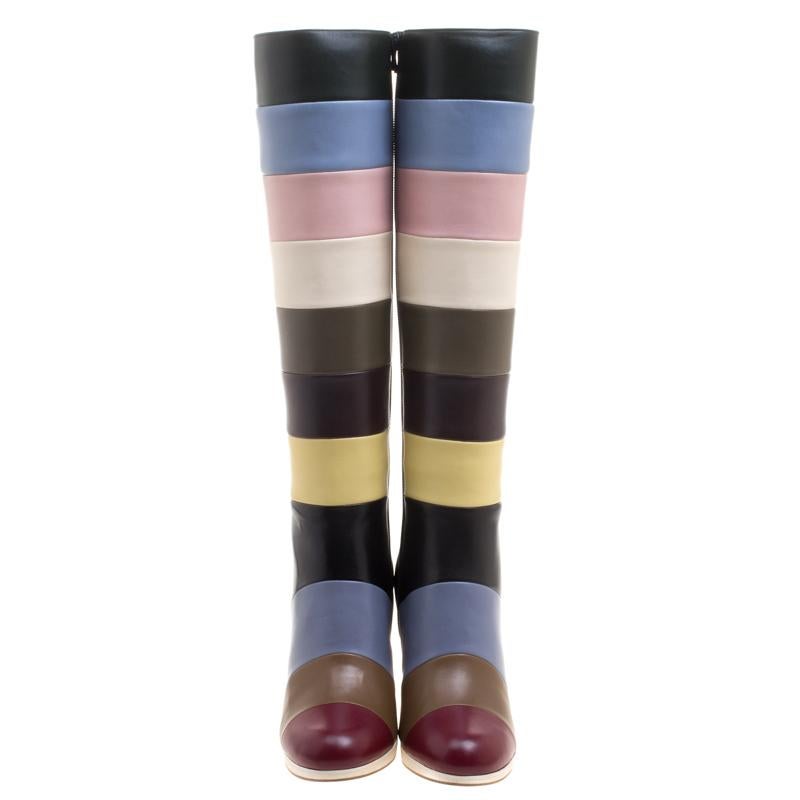 Get set to dazzle wherever you go with this pair of knee boots from Valentino. Crafted from leather they feature a broad striped pattern in multicolors and block heels. Add these fashionable boots to your wardrobe right away.

Includes: Original