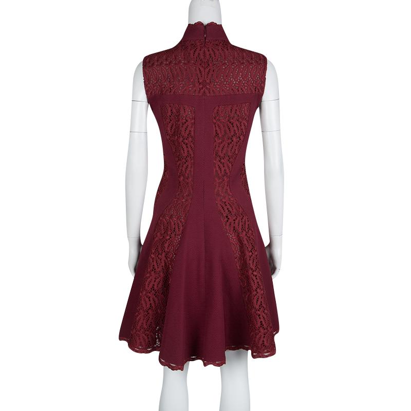 Flaunting a burgundy hue, this sleeveless dress is from the house of Alexander McQueen. It is a beautiful evening outfit featuring lace details, a high collar, a fitted waist and scallop hem. It is secured with a zip closure at the rear.

Includes: