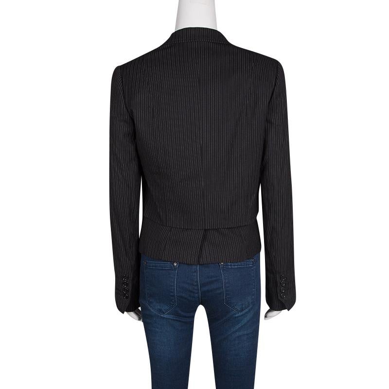 Dolce and Gabbana's blazer will be your top pick for the season. It is layered at the front for a cool structured look. Cut to an impressive silhouette; the style has the pin-striped pattern all over. Completed with a buttoned closure and two flap