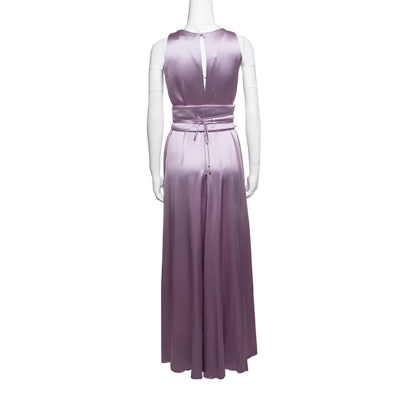 Leave everyone in awe whenever you step out in this gorgeous gown from CH Carolina Herrera. Made from the finest silk, the purple gown has a dreamy silhouette with a pleated neckline and belted neckline with ties. You can assemble the complete look