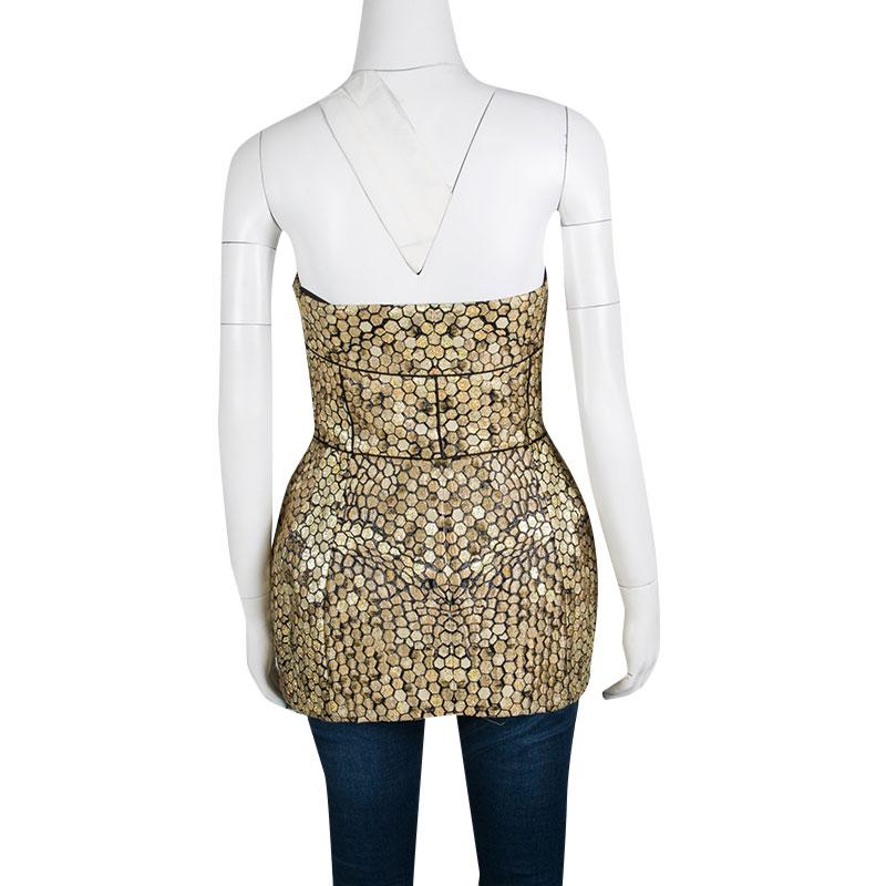 Alexander McQueen for its Spring Summer 2013 collection took honey in all its form and translated it into some stunning attire. This strapless corset top is styled with honeycomb pattern throughout along with a dramatic shape that beautifies its