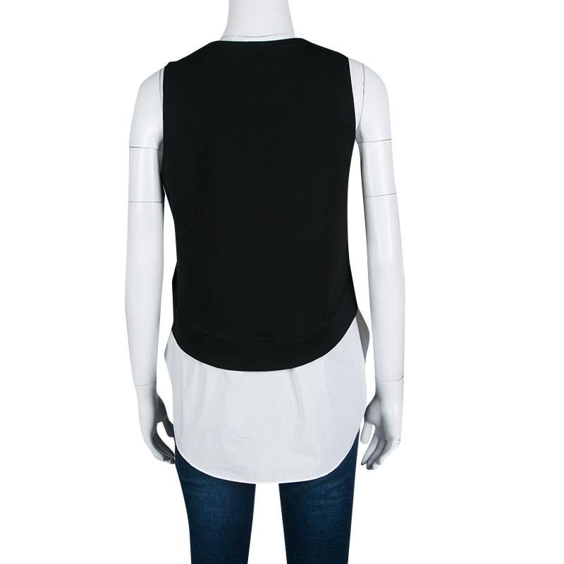 The colorblock monochrome design, lovely embroidery on the front, and layered silhouette combine to make this top from Derek Lam a fun, evening piece. The simple round neck and sleeveless design complete this lovely top. Complement it with a pair of
