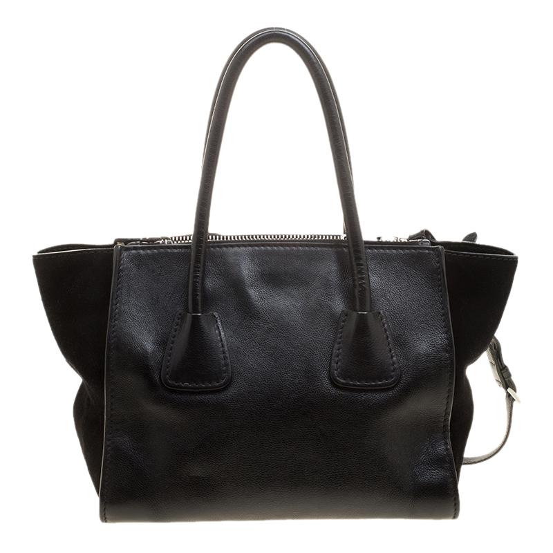 Step out with this sensational black bag and grab all the attention. Crafted from lasting leather and suede, it is an amazing blend of style and utility. This smartly designed creation by Prada has a nylon interior lining.

Includes: Original