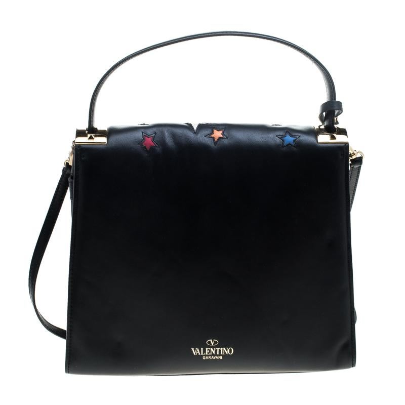 This eye catching bag from Valentino's My Rockstud collection is crafted from black leather and was part of the Resort 2016 Collection. The bag has butterflies and stars embroidered on the exterior, a single top handle, a removable shoulder strap, a