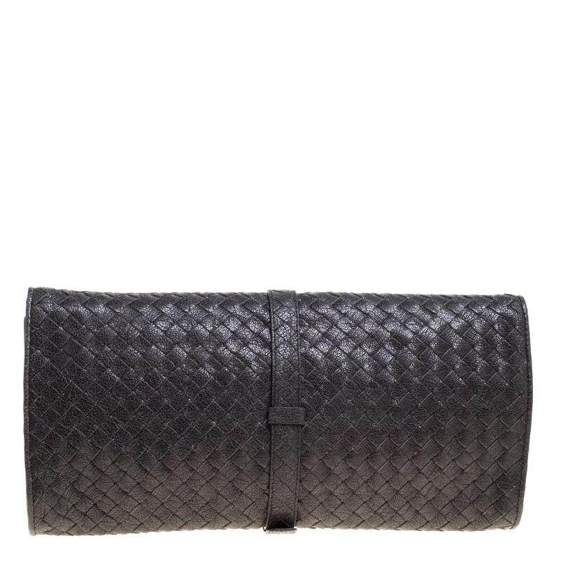 This gorgeous clutch from Bottega Veneta is crafted from shimmering leather and has the signature intrecciato pattern all over it. The flap secured by a buckle closure opens to a suede lined interior that can hold all your necessities. Carry this to