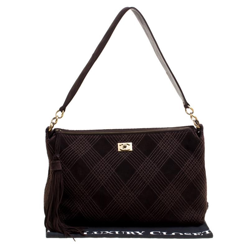 Chanel is defined by its exalted craftsmanship, and this shoulder bag is a true testimony of their flair. This bag is an elegant combination of style, sophistication, and structure. The brown quilted suede exterior is paired with contrasting wild
