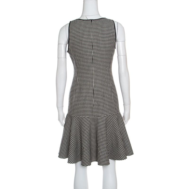 Simple and sophisticated, this Lexi dress from Ralph Lauren is for those who prefer fashion coupled with comfort. The dress is made of a wool and cashmere blend and features a monochrome houndstooth pattern all over it. It flaunts leather trim