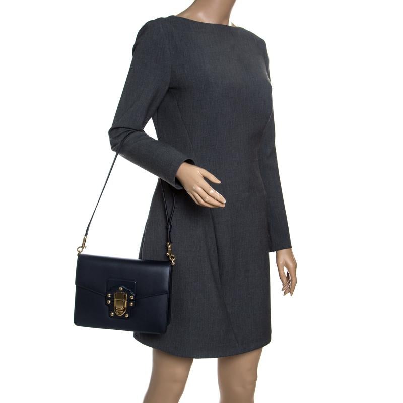 Shoulder bags as pretty as this one by Dolce&Gabbana are not creations you find every day. That's why this bag is worthy of a place in your closet. It has been crafted from leather in navy blue and styled with a flip lock on the flap to secure the